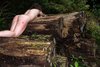 Nudist Woman Crawling on Wet Logs
