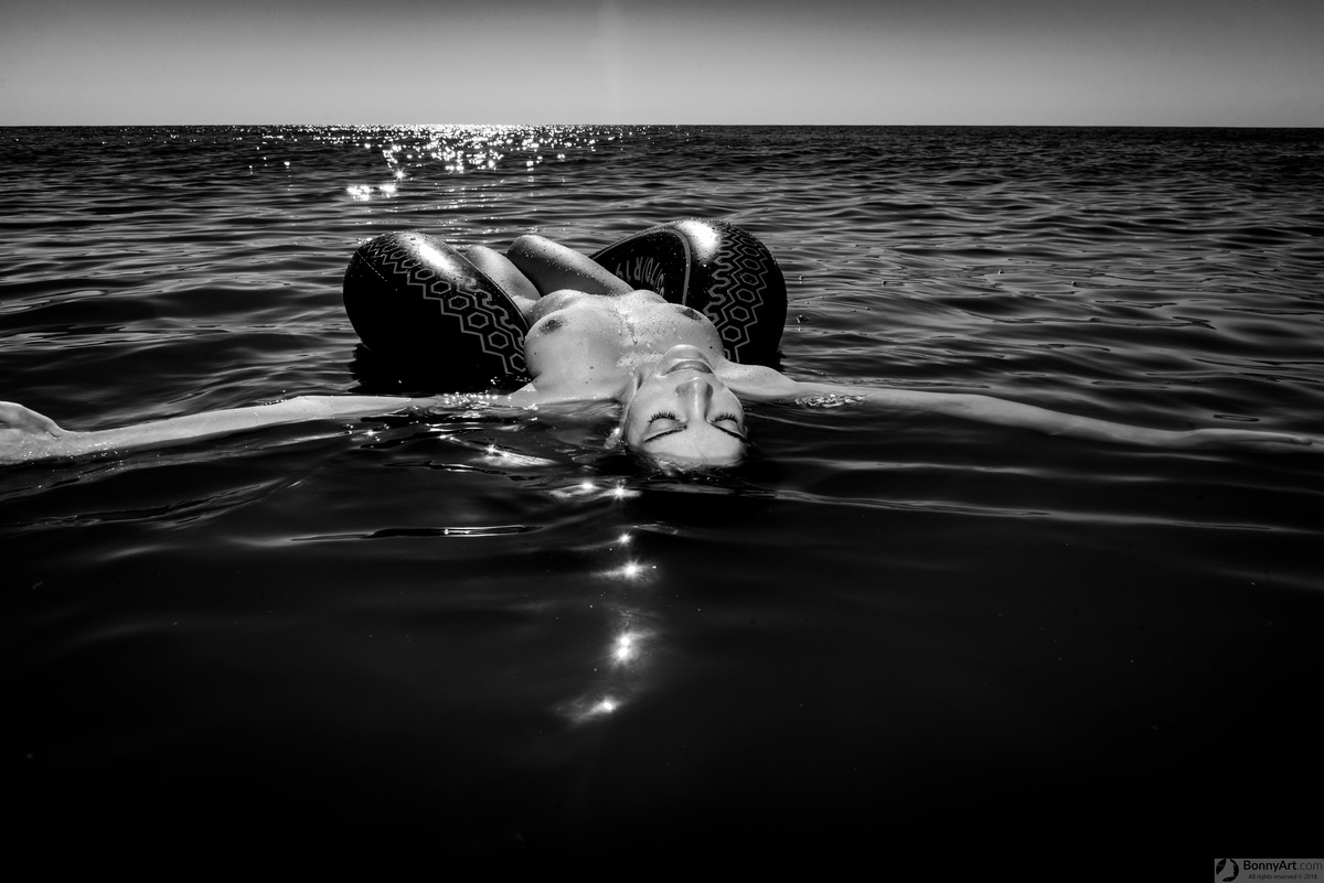 Water Nymph Floating on Dark Black Sea