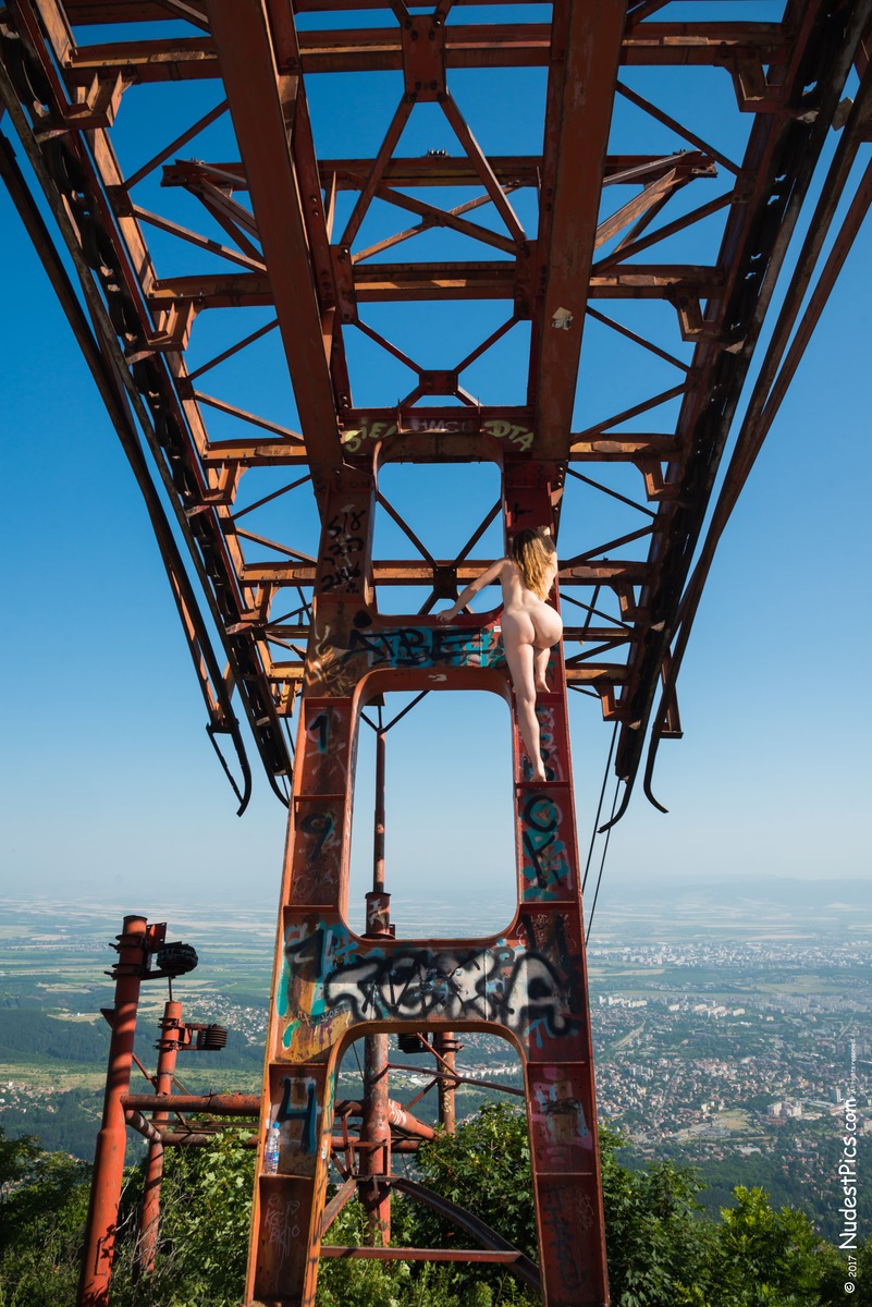Fearless Naked Girl Climbing on Cable Car's Pillar
