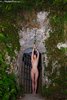 Naked Girl on the Door of her Cave House